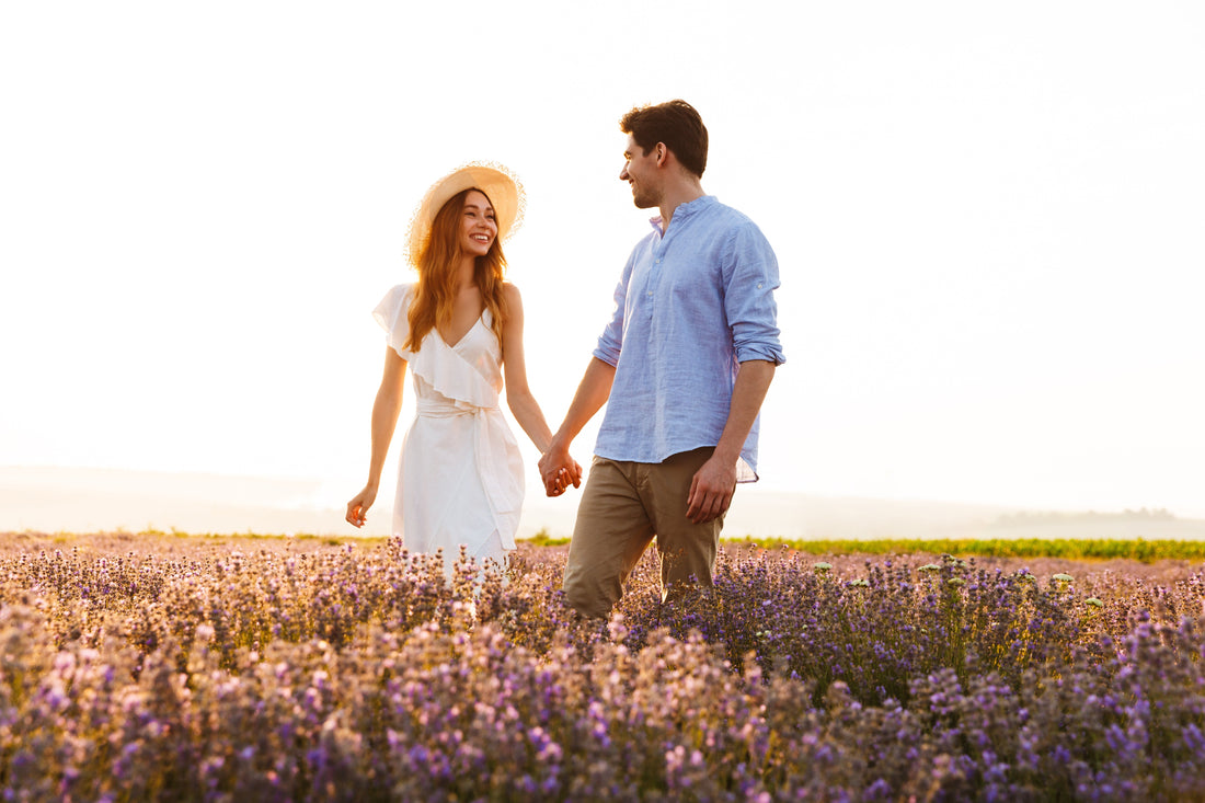 A happy couple walking through a meadow