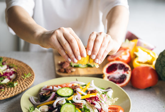 A close up image of a woman preparing a healthy meal